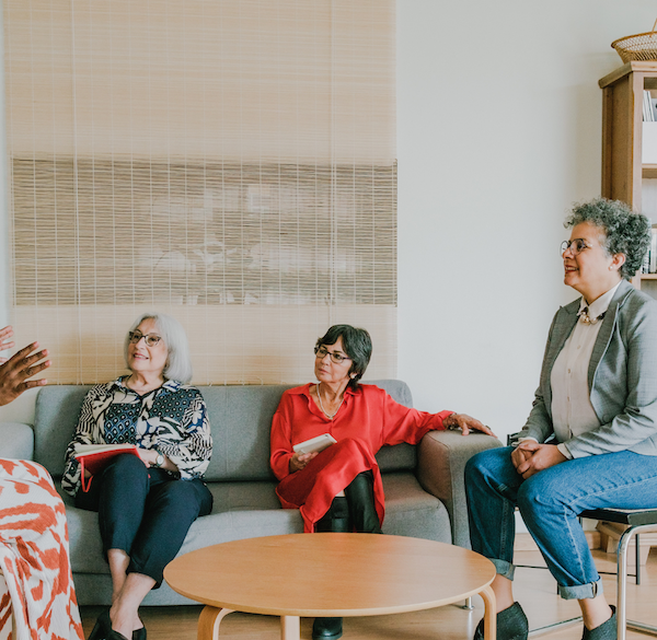 A roundtable discussion of a group of elderly women.