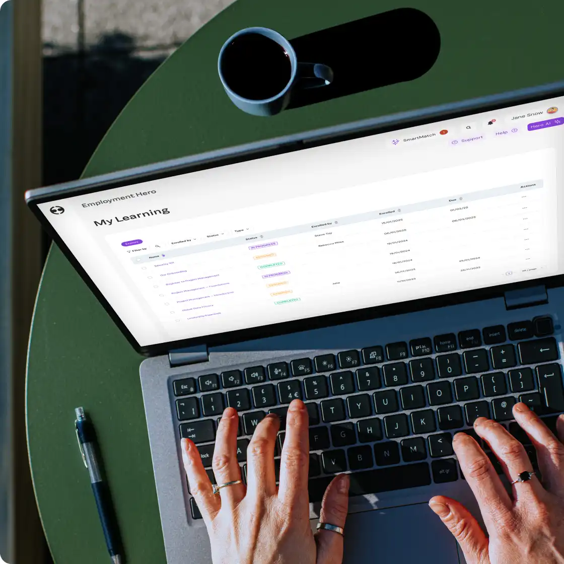 A person focused on typing on a laptop computer, with hands positioned on the keyboard.
